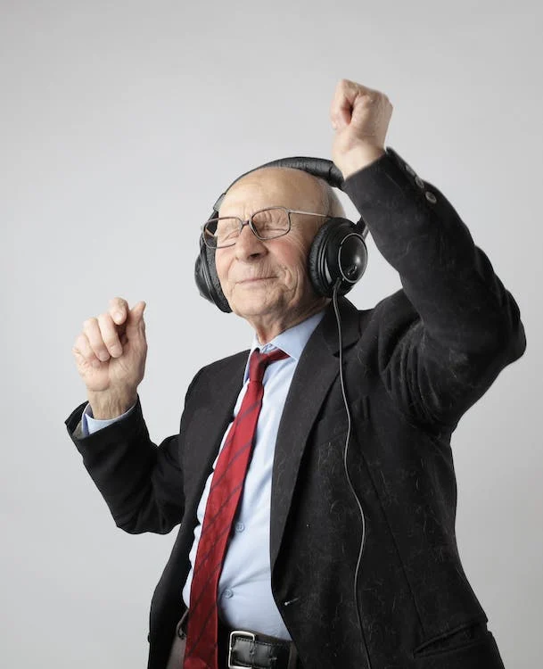 “Joyful senior man dancing to the rhythm of his secure and well-planned retirement, thanks to the detailed analysis, income estimations, optimized strategies, and holistic retirement planning provided by Reignmakers, ensuring a harmonious blend of financial prosperity and peace of mind in his golden years.”